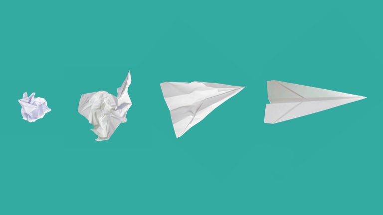 A sequence of four paper objects from a crumpled ball to a finished paper airplane, showing a process of creation.