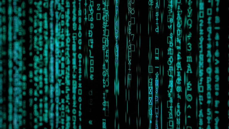 Cascading green computer code characters on a black screen, creating a "digital rain" effect.